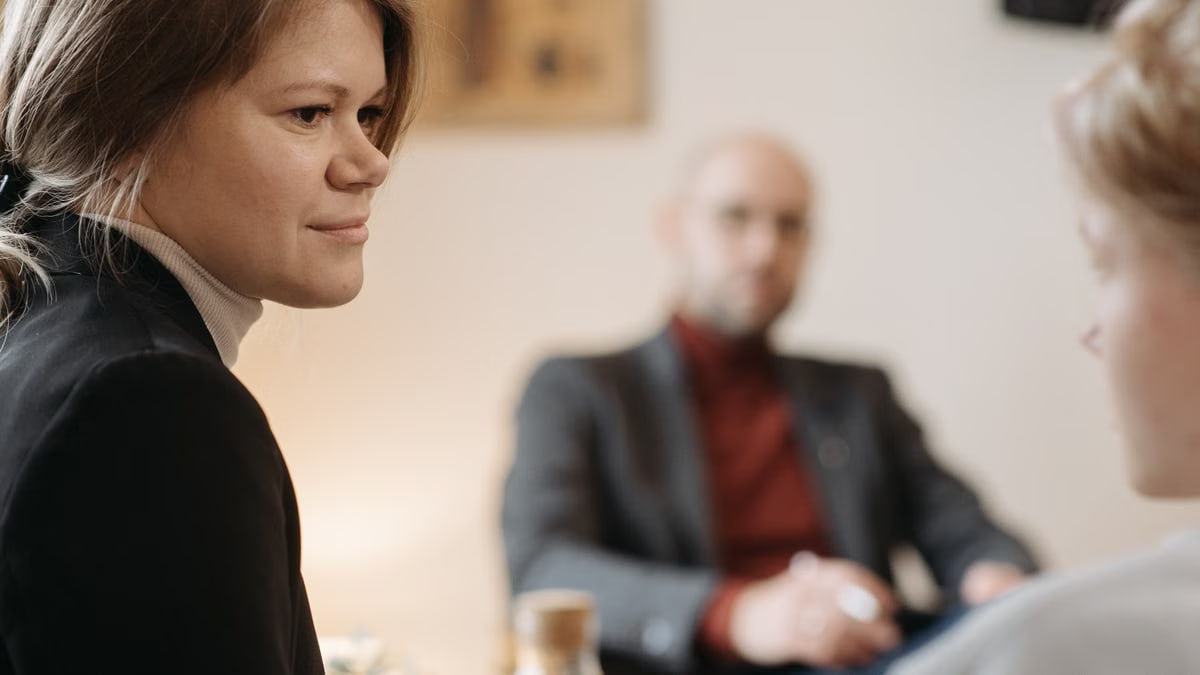 A therapy session in progress with a therapist and two patients in focus.